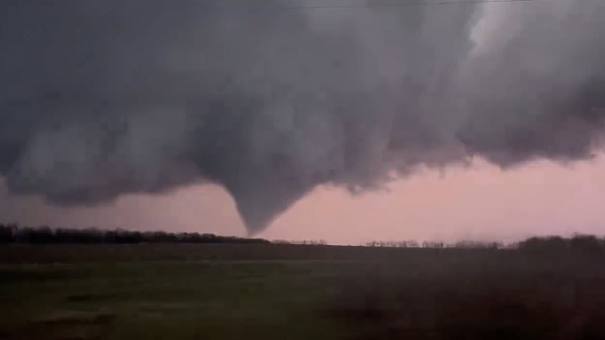 Kansas City residents are warned to shelter inside as heart-stopping video shows massive tornado touching down and softball-sized hail raining down on the region