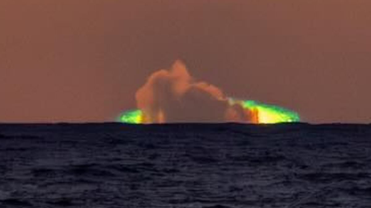 Creepy green flash lights up the sky as the sun sets over the ocean - as witnesses brand it 